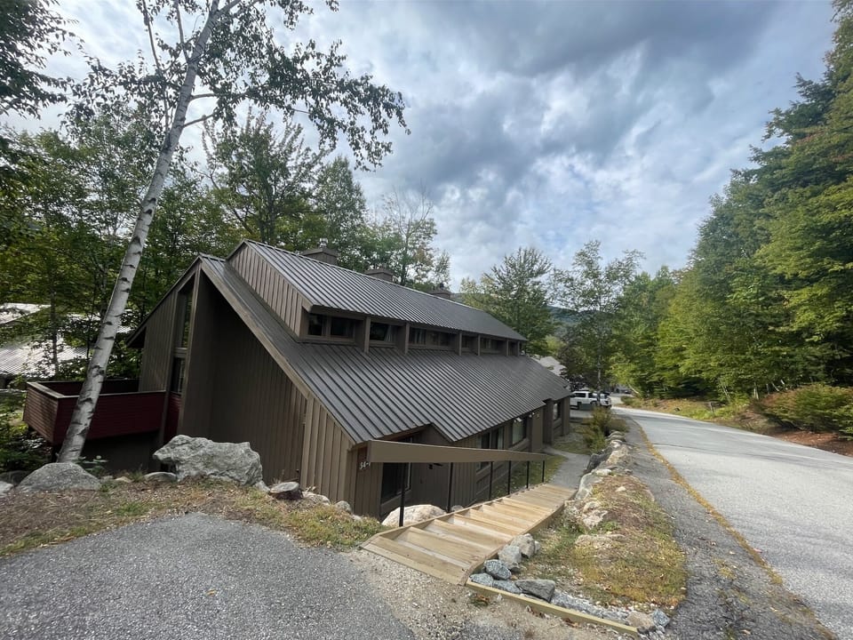 The middle unit of three in a beautifully wooded neighborhood.