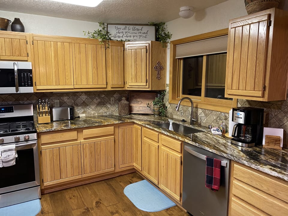Kitchen with new stainless steel appliances.