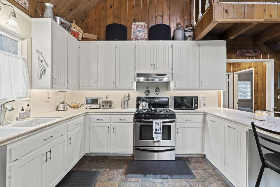 Full kitchen with fridge, stove, oven, microwave, toaster, blender, & more.