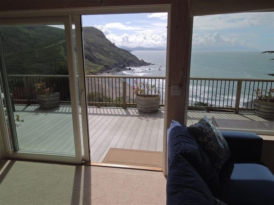 Living room opens to deck for sites and sounds of the Pacific