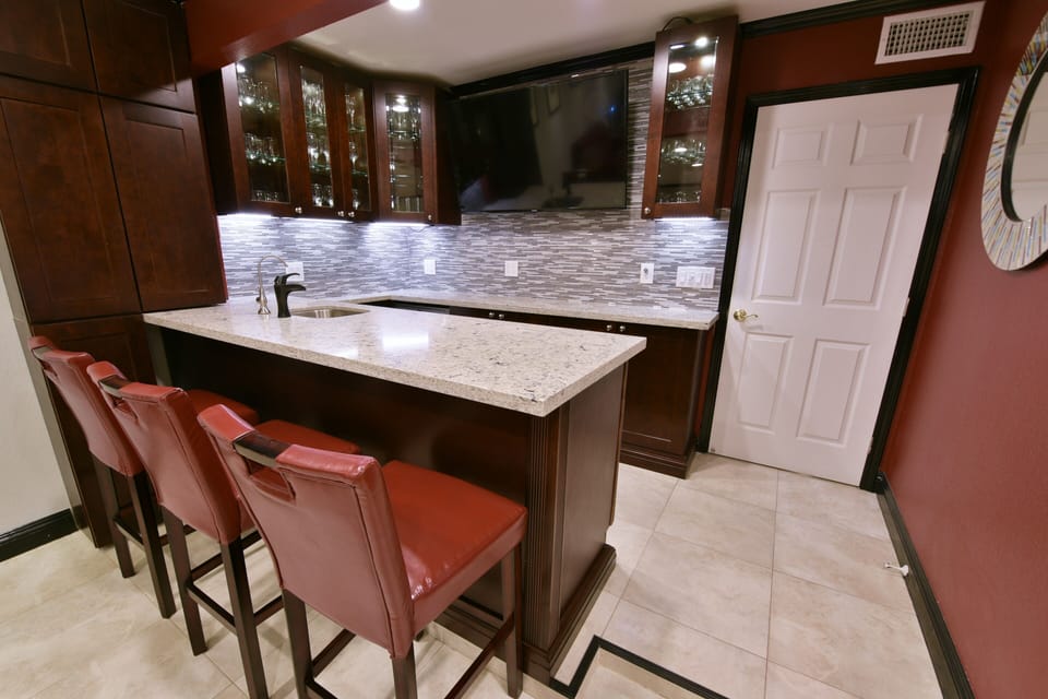 Open bar - quarts counters, TV, bev. center, ice maker, dishwasher, stemware