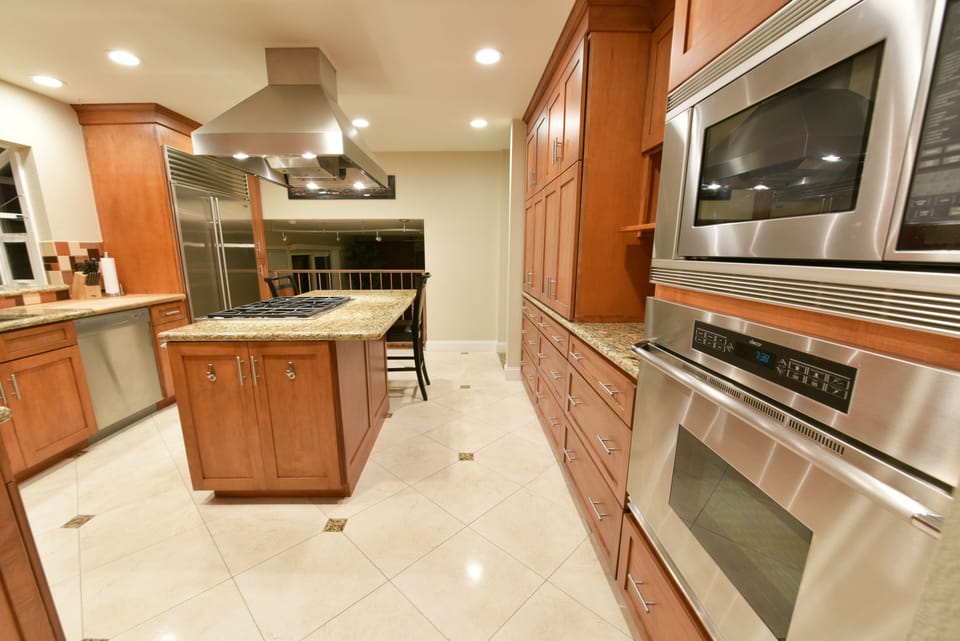 Gourmet kitchen with granite flooring and counters. Stocked with many appliances