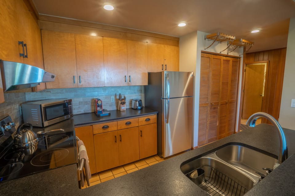 The kitchen also includes a tea kettle, coffee maker, toaster and crock pot. 