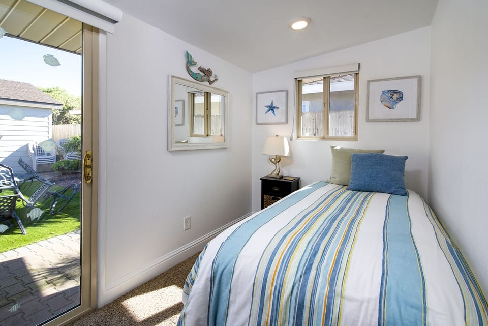 This room off the twin BR has a twin bed, washer & dryer, and door to backyard.