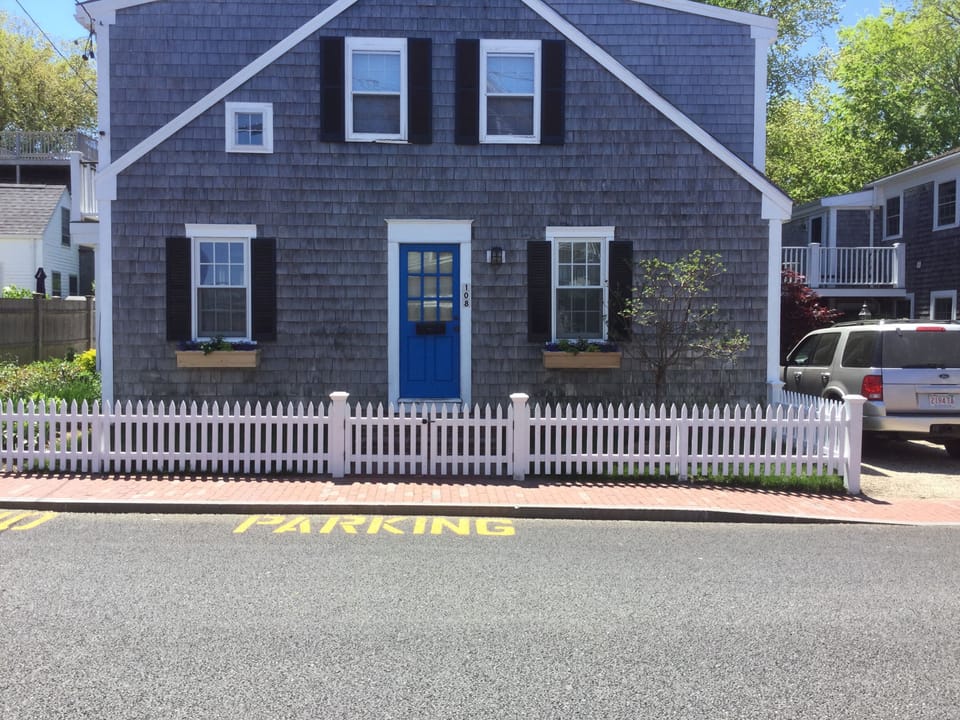 Front of house with new fence and window boxes