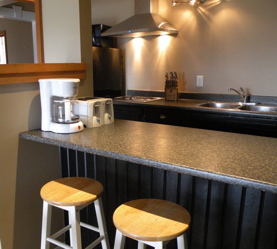 stocked kitchenette: 2-burner stovetop, microwave, toaster, kettle, coffee maker