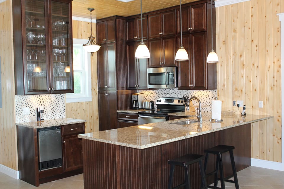 Gourmet kitchen stocked for entertaining. Separate ice maker, granite counters.