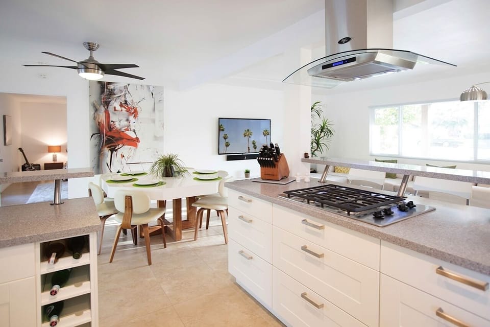 Gas Range, Quartz Counters, Wine Racks, Self-Closing Drawers, Cabinets.