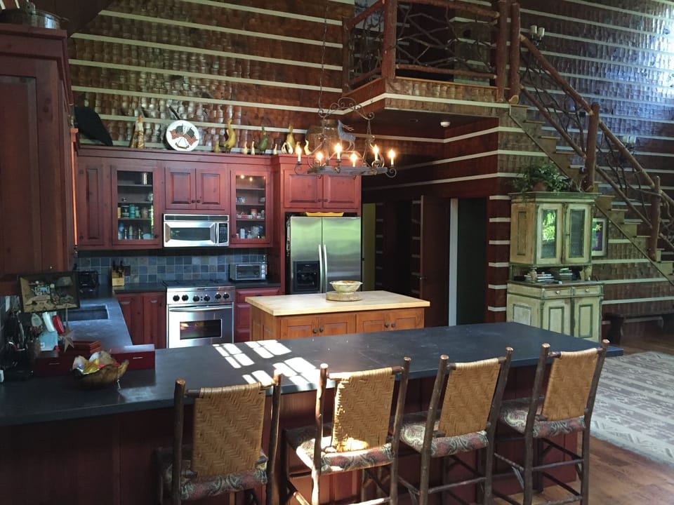 Open kitchen with modern appliances, island and ample counter space and seating.