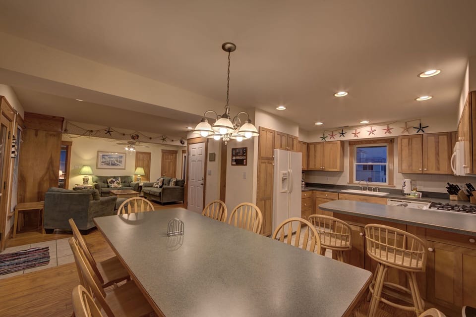 main level of house showing kitchen, dining table and main guest room
