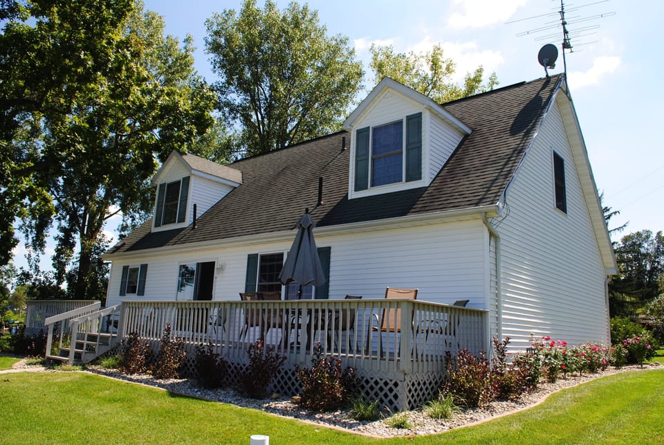 Huge full length deck. Table with 6 chairs, Adirondack chairs, & gas grill