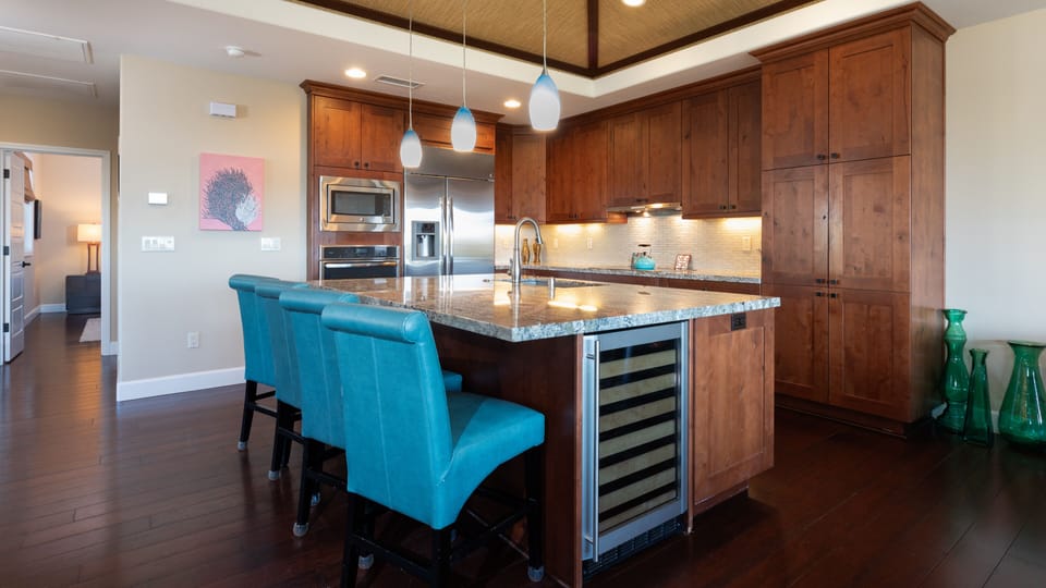 Large kitchen island with seating and wine fridge