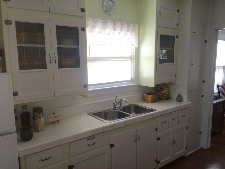 Original 1931 kitchen cabinets, ice box on right is now pantry