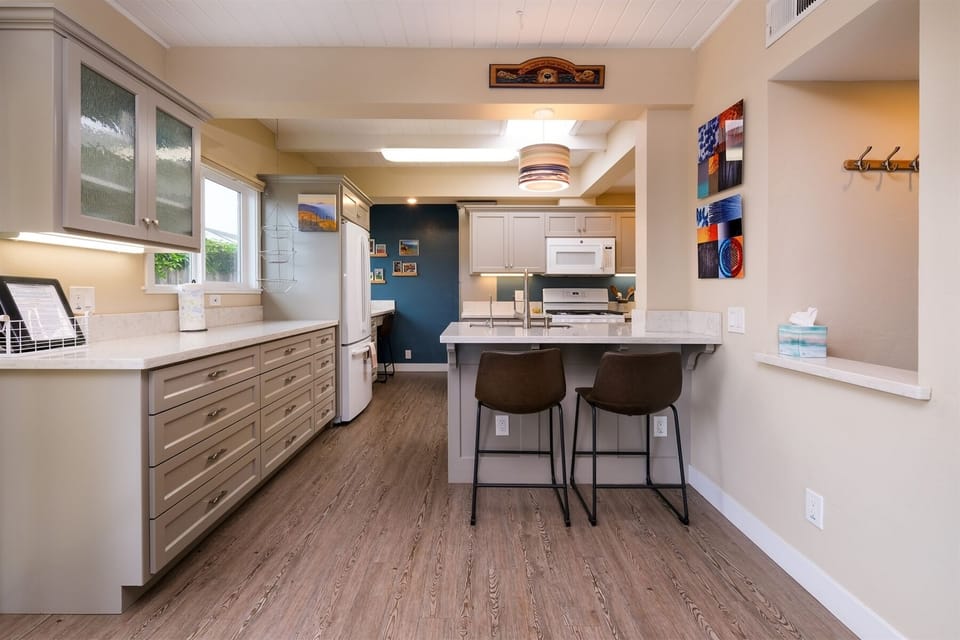 Kitchen area open to dining room features bar seating for 2