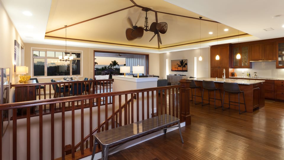 Large open concept floor plan with vaulted grass cloth ceilings