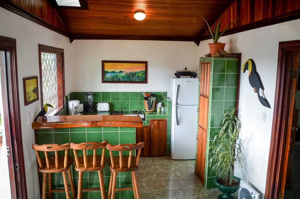 Fully equipped kitchen with teak breakfast bar.
