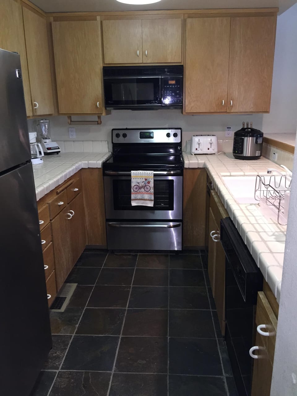Fully equipped kitchen with new stainless steel induction range and refrigerator
