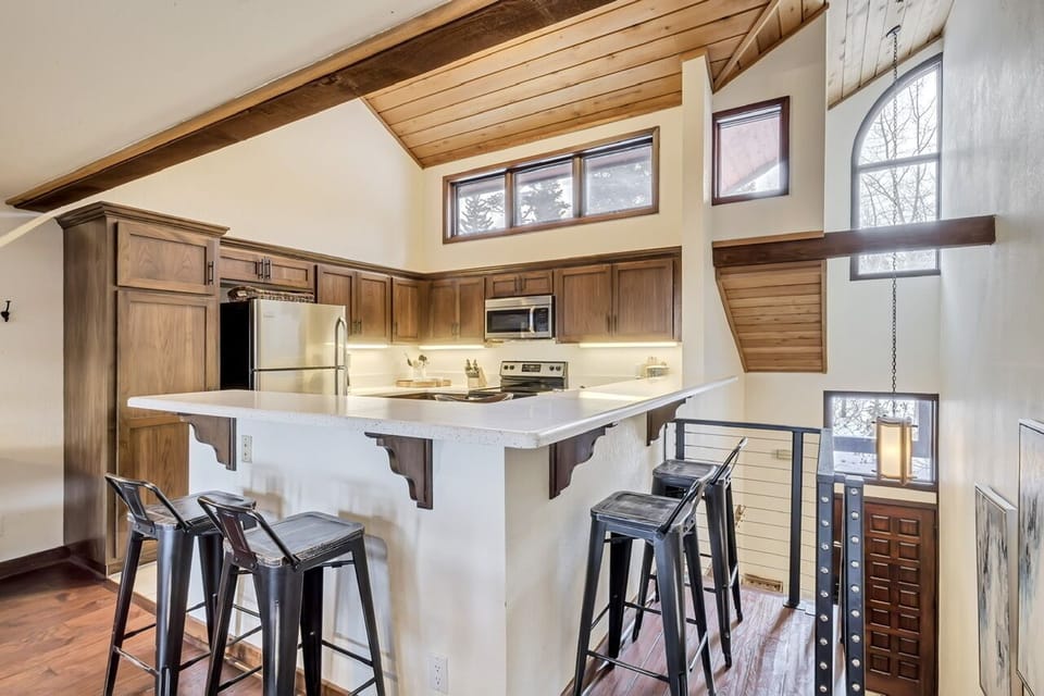 Seating for 4 at kitchen bar height counter.