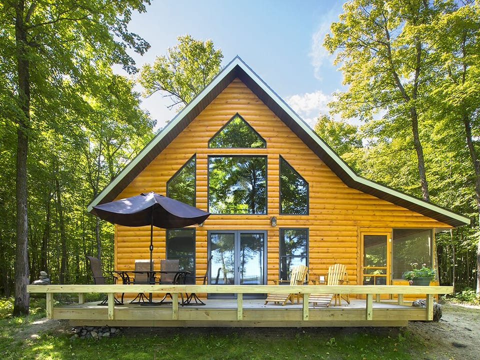 Wall of windows, deck and screen porch - cabin looks out onto Strawberry Lake