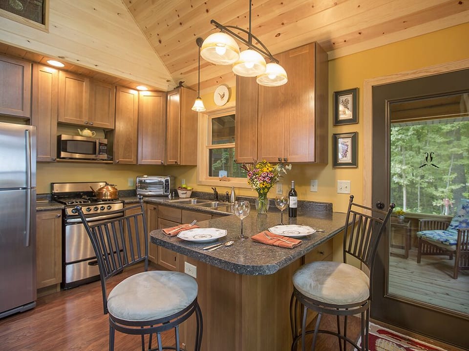 Kitchen view and screen porch view through front door