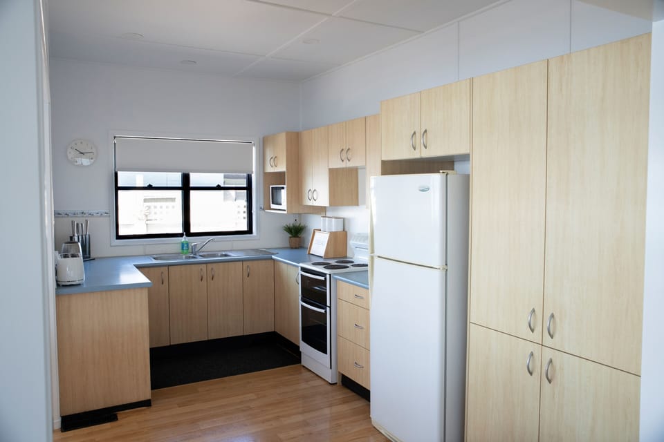Self contained kitchen with complimentary tea, coffee, sugar, milk & biscuits.