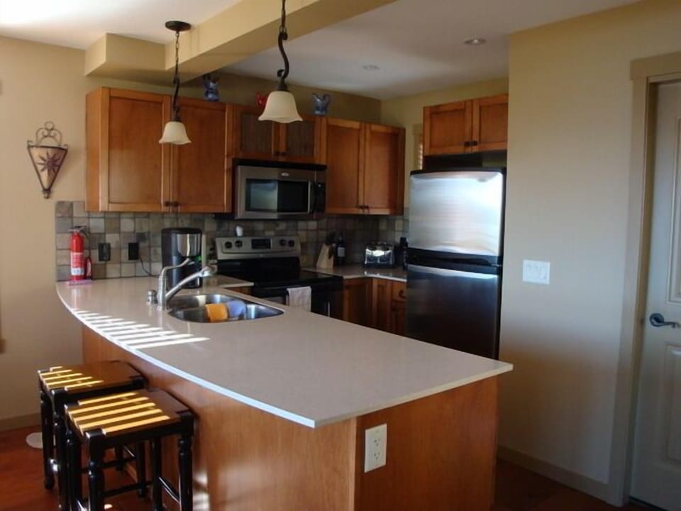 Kitchen, with stainless steal appliances, granite counter tops, and slate floors