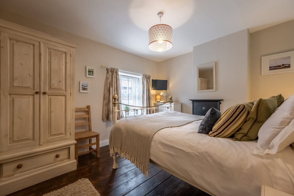 First floor: Master bedroom with king-size brass bedstead