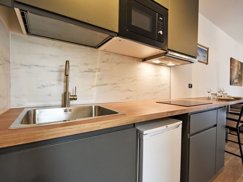 Countertop, Kitchen, Furniture, Interior Design, Kitchen Appliance, Cabinetry, Flooring, Wood, Major Appliance, Floor