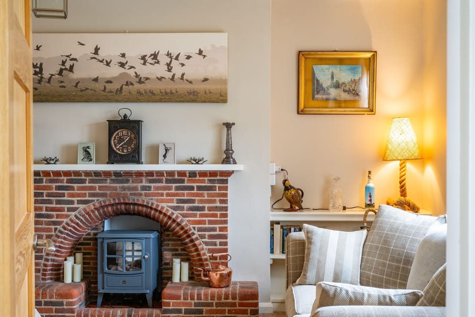 Ground floor: Sitting room with electric flame fireplace