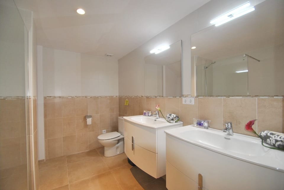 Large shower room next to hall on pool level.