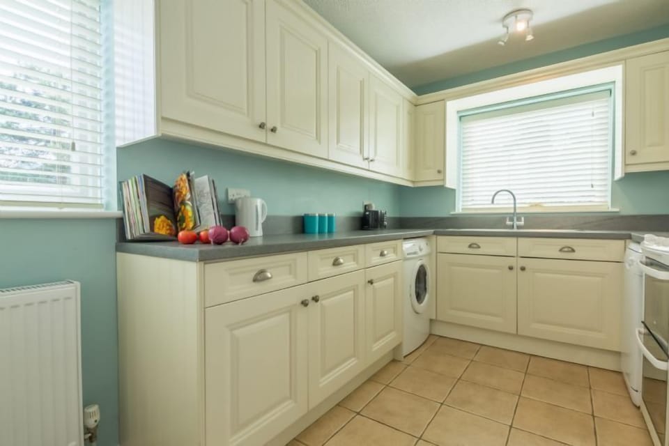 The fitted kitchen also has a small table