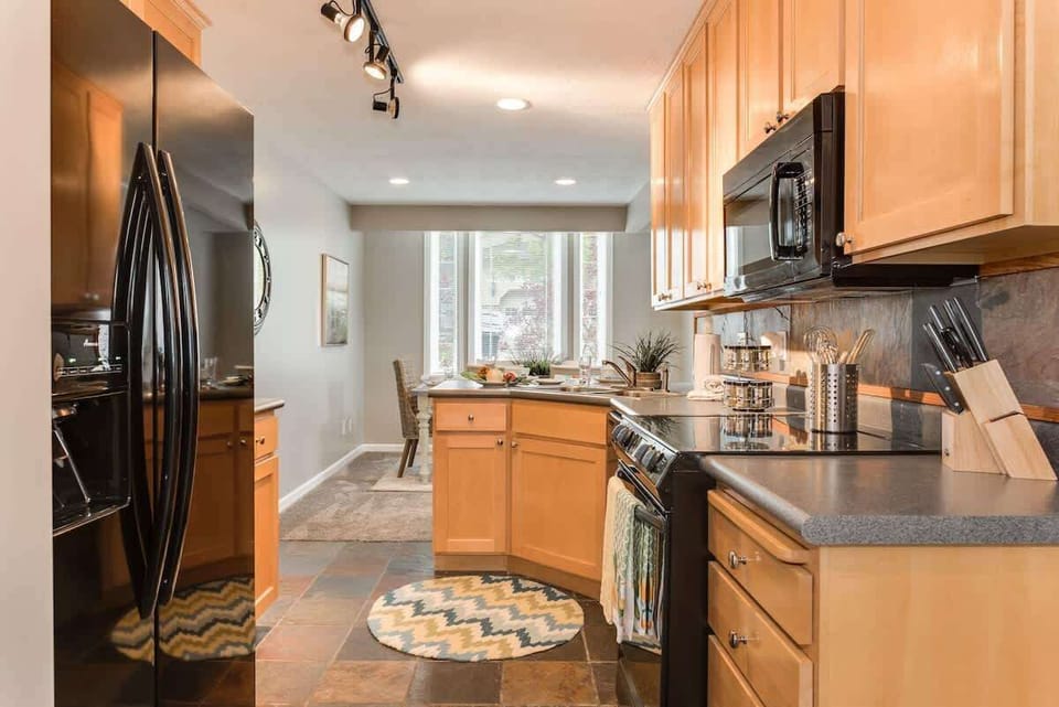 Updated appliances, slate tile floor, and fully stocked with serveware and cutlery