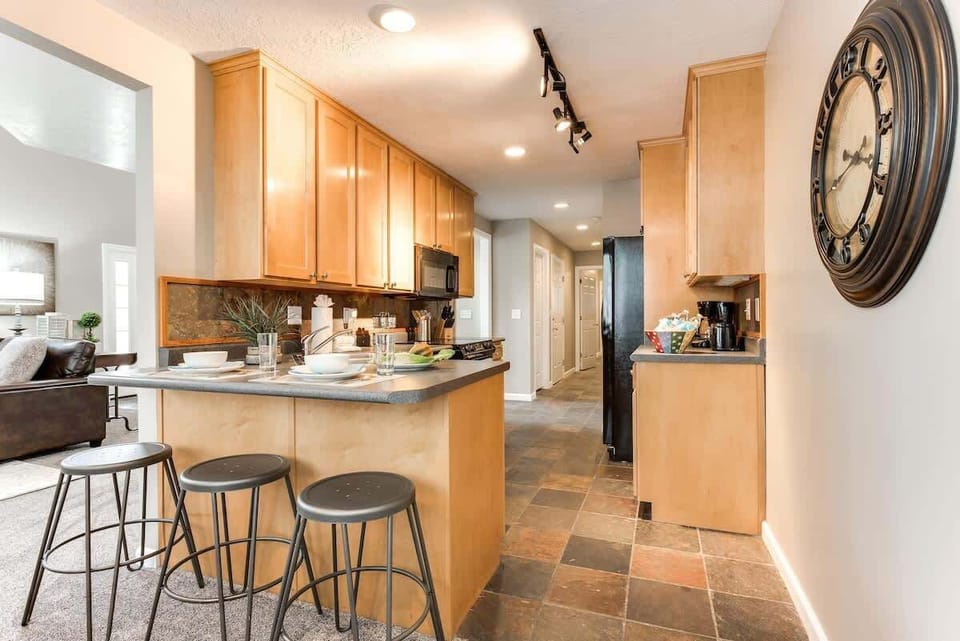 Kitchen with bar seating for 3 and slate tile floors