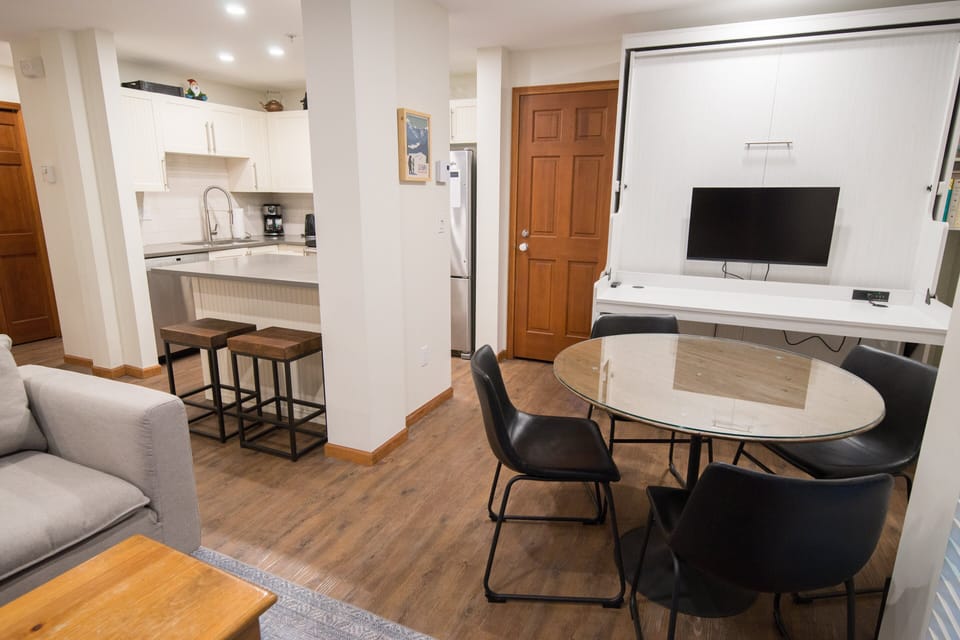 Dining area for four with a fold down double murphy bed in the back