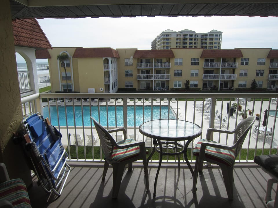 Balcony overlooks Olympic size pool, kiddie pool and courtyard, ocean to east.