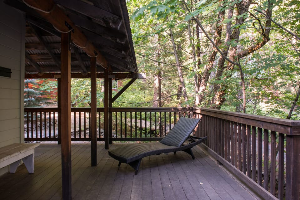 Deck with chaise lounge above little creek