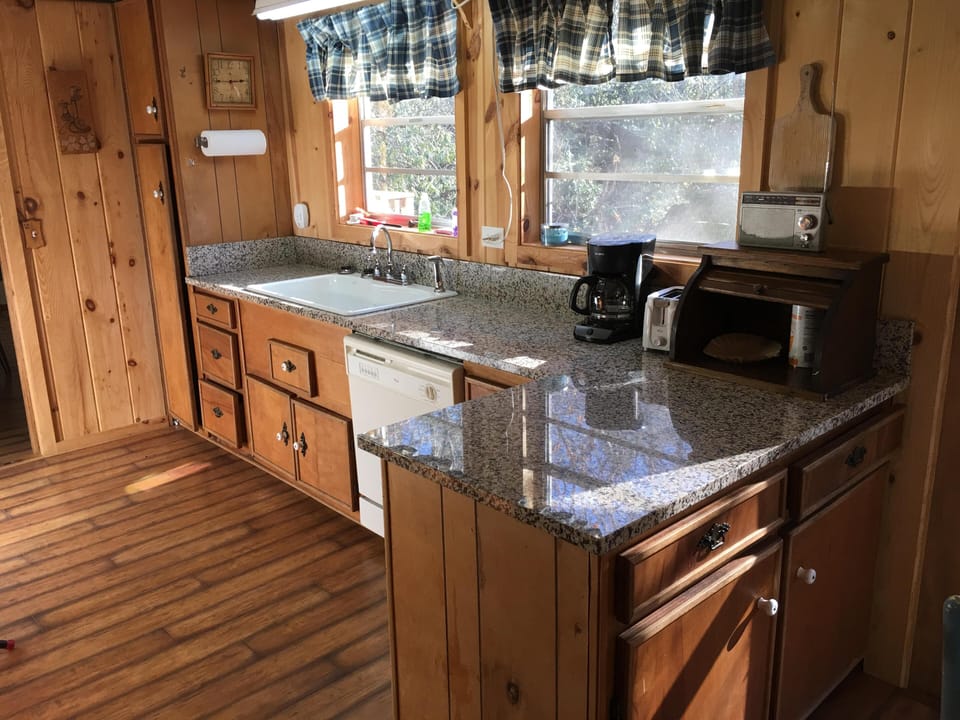 Kitchen with dishwasher and granite countertops