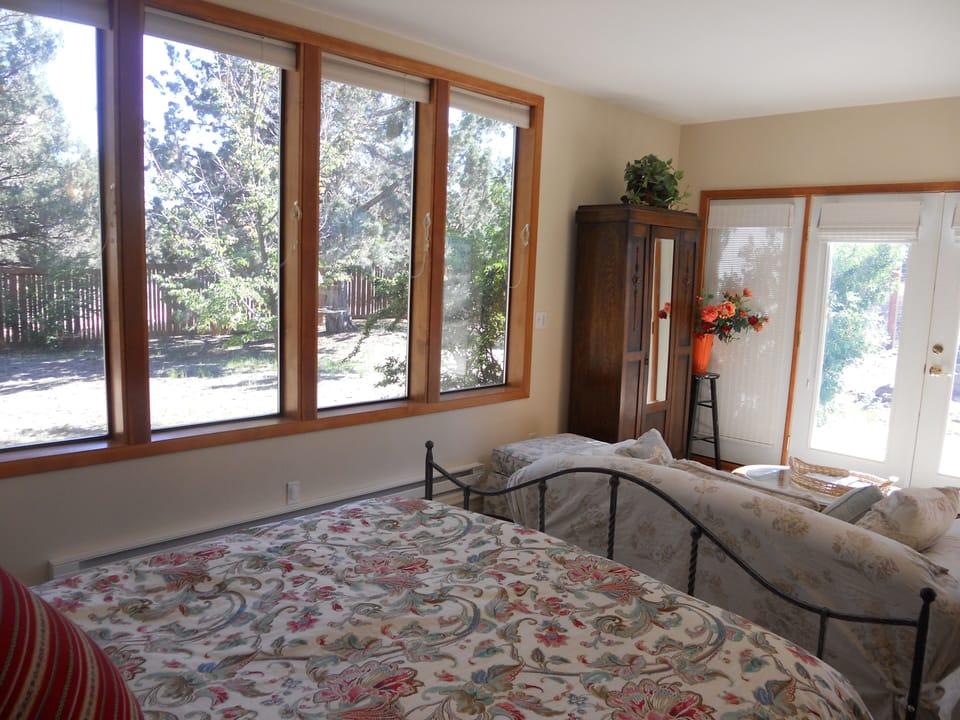 Large downstairs bedroom with front yard and garden views.