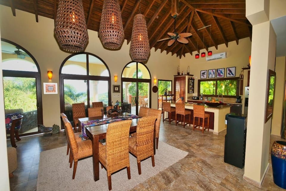 Spacious dining and kitchen area with vaulted ceilings and natural light