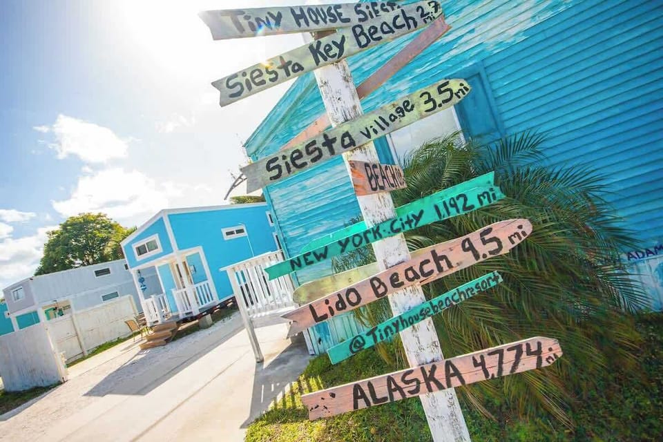 Colorful and beachy scene signpost