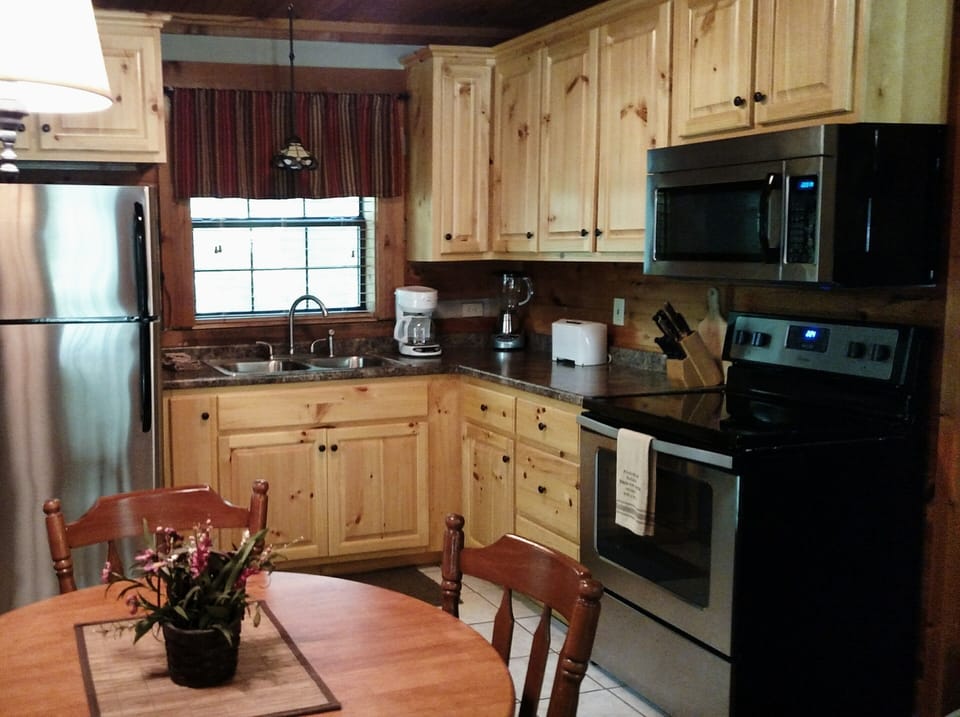 Custom built pine cabinets with stainless steel appliances. Fully equipped.