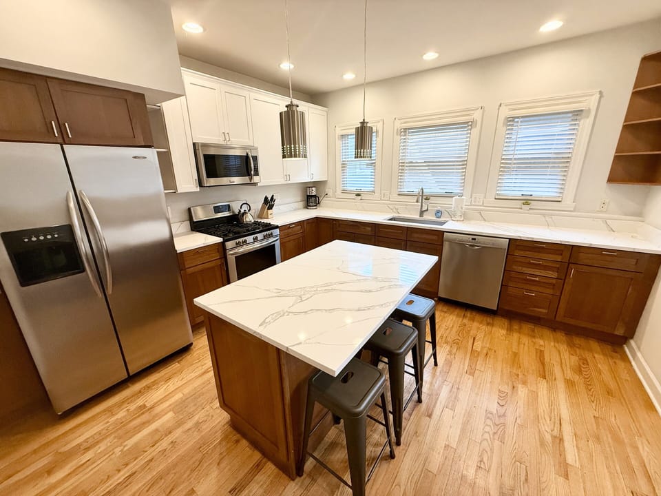 Kitchen with center island, quartz countertops, stainless appliances