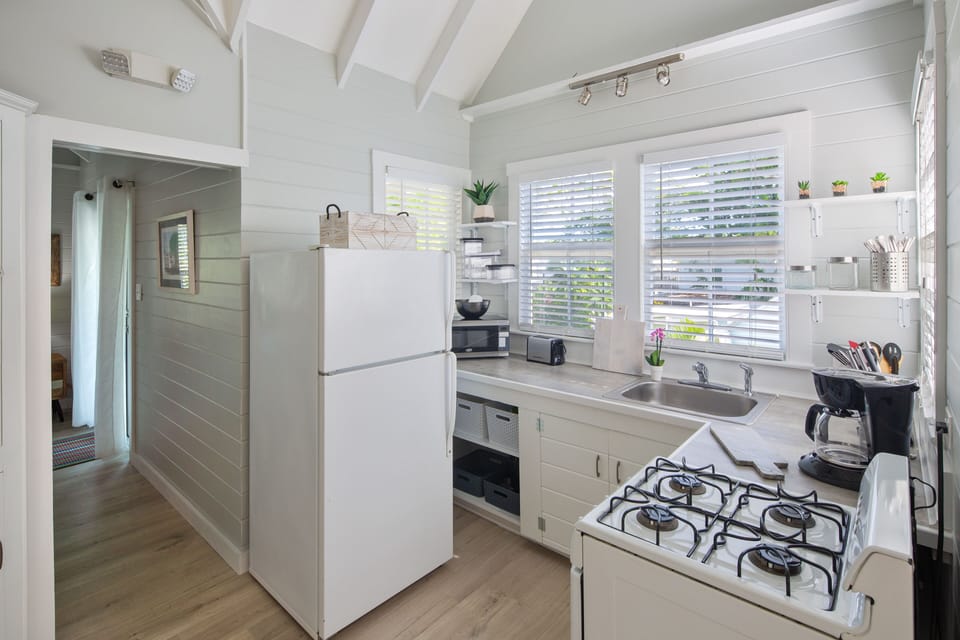 View of kitchen and hallway leading back to bedroom.