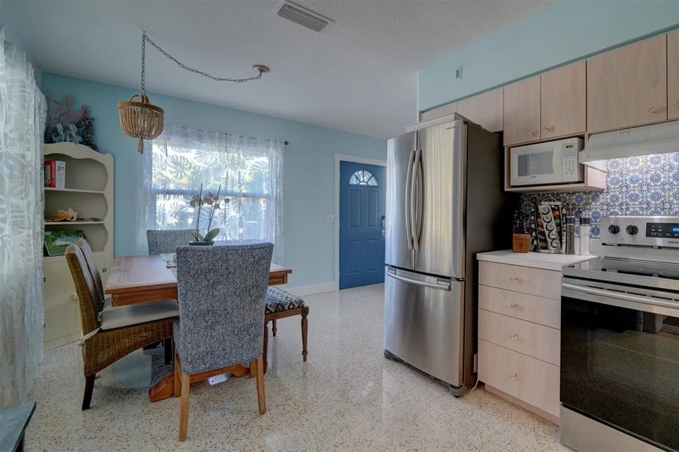 Leaving the kitchen toward the front door, find new dining table that can seat 6