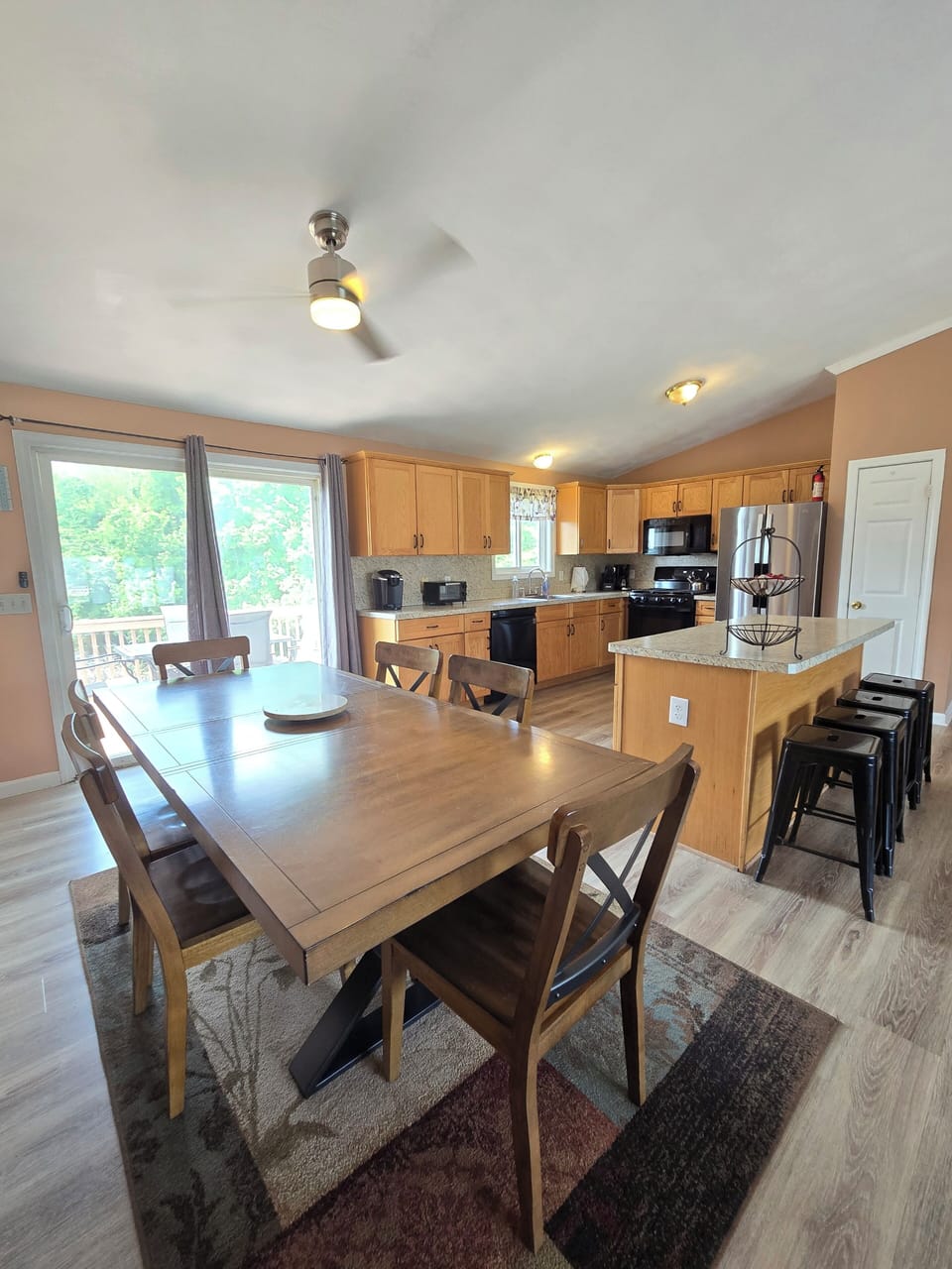 large dining room, kitchen combination with walk out patio deck 