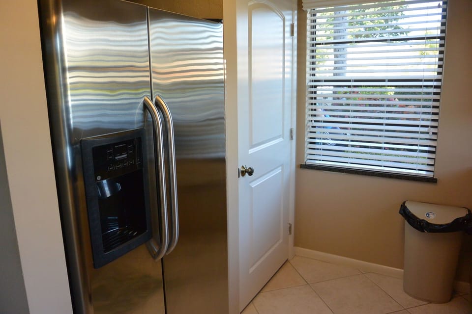 Large kitchen pantry, side by side Refrigerator with water/ice on door.