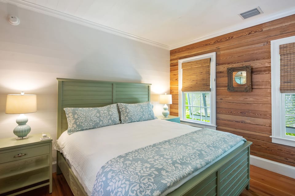 King bedroom with bedside lighting and Dade County pine.