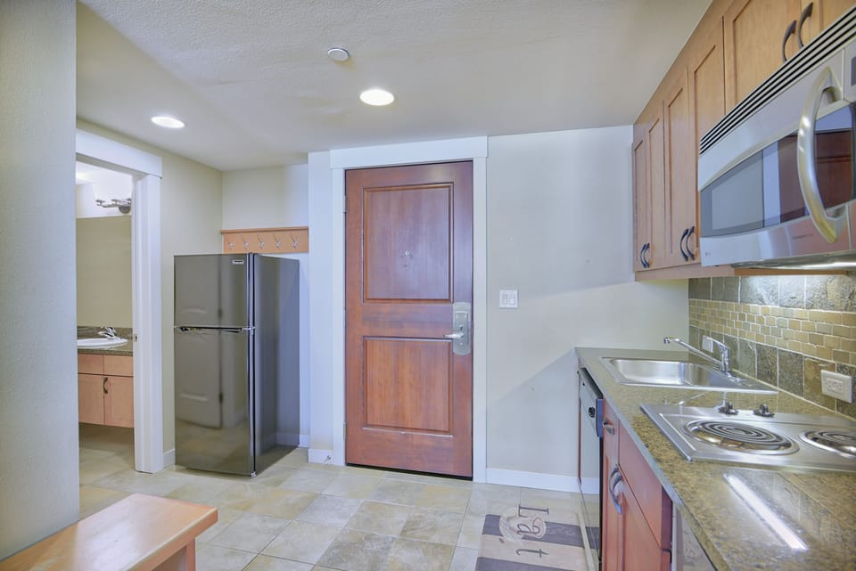 Kitchen - Full size refrigerator next to the entry door.