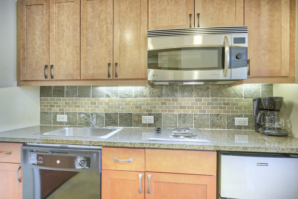 Kitchen - Complete with coffee maker, toaster, and above range microwave.