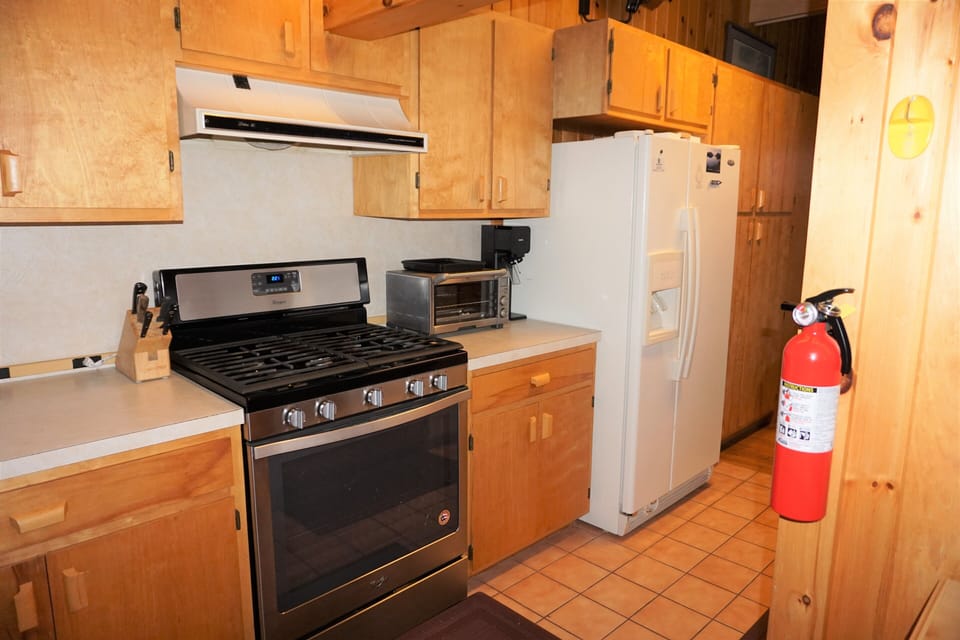 Galley Kitchen with custom made cabinets with ice /water dispenser  refrigerator